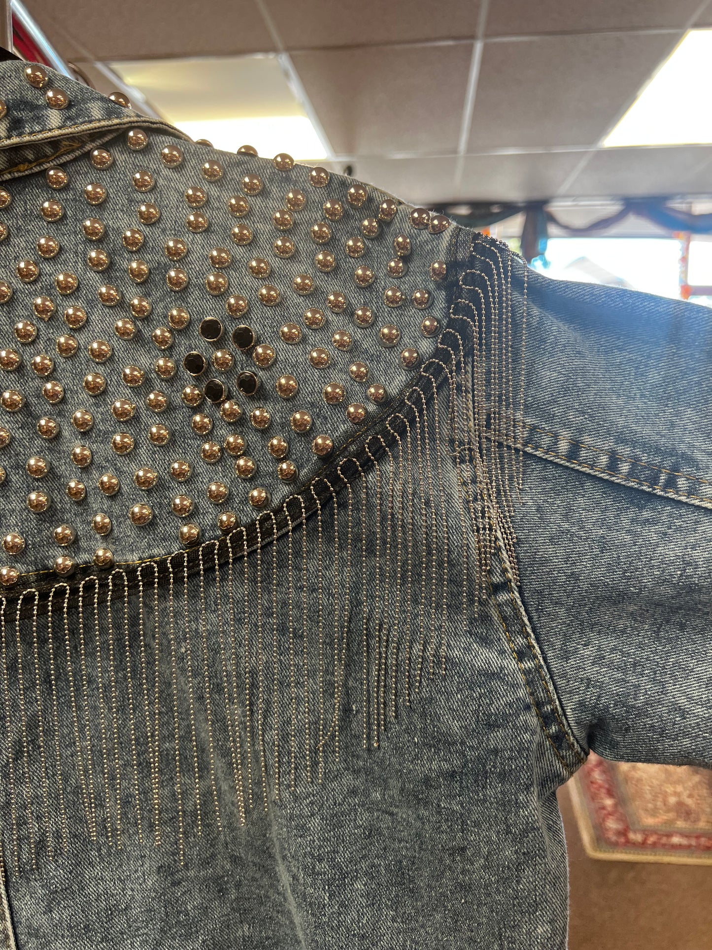 Fringe studded denim jacket.