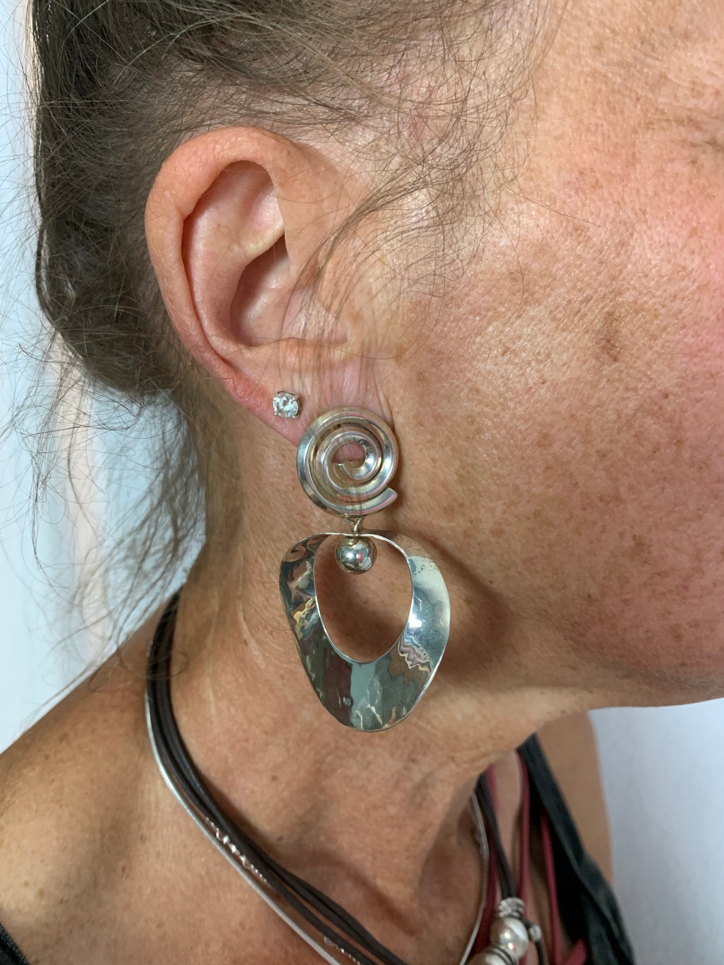 Sterling Silver spiral post hammered earrings, total length 2”.