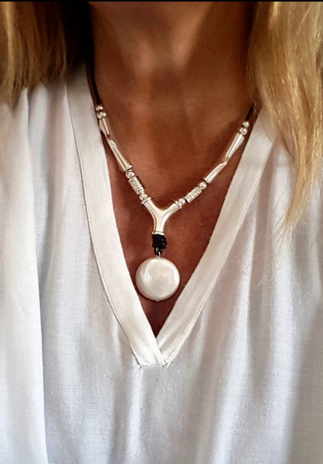 Leather, brass, solitaire pearl necklace.