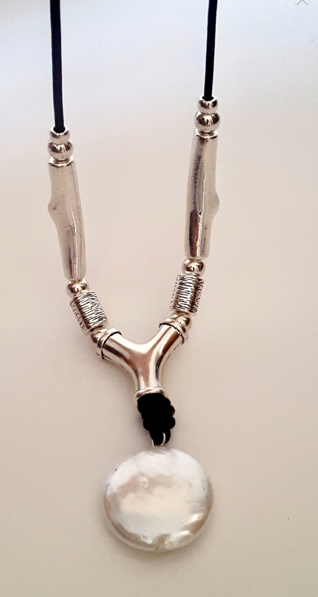 Leather, brass, solitaire pearl necklace.
