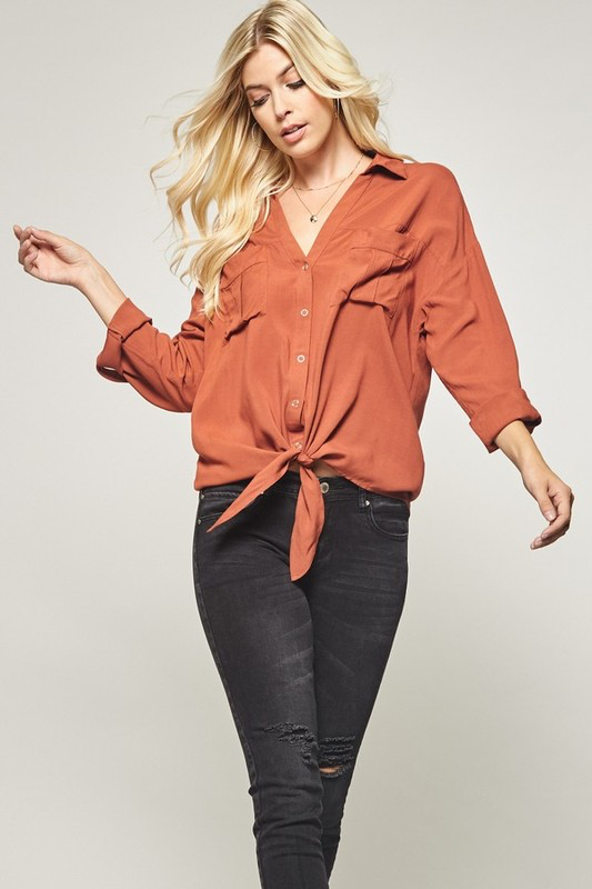 Button down shirt top in solid with knot tie on front.