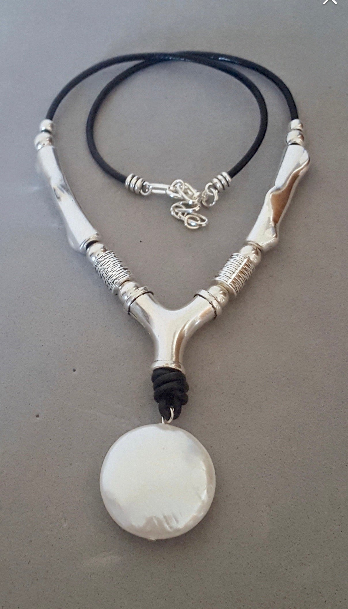 Leather, brass, solitaire pearl necklace.