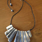 Adjustable aluminum 9 cane necklace.