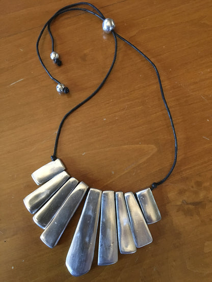 Adjustable aluminum 9 cane necklace.