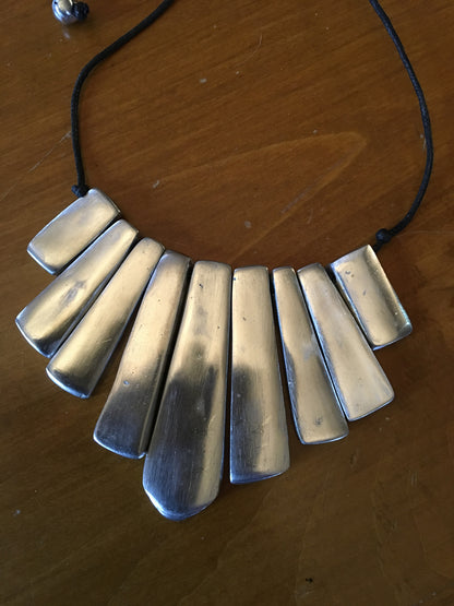 Adjustable aluminum 9 cane necklace.