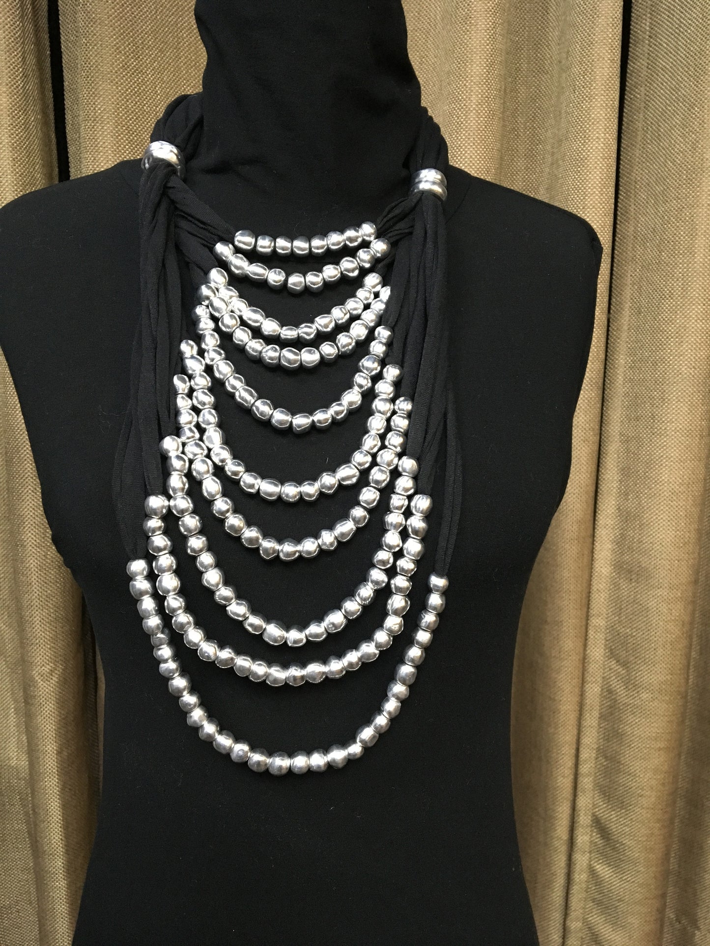 Adjustable long multi thread jersey and aluminum balls necklace.