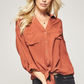 Button down shirt top in solid with knot tie on front.